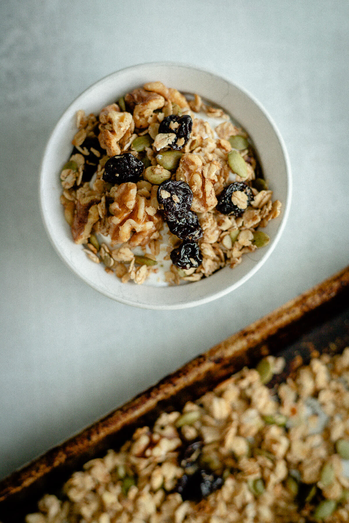 bowl of cherry walnut granola in a bowl with milk