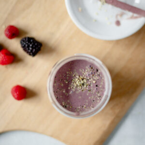 top down view of a gut friendly triple berry smoothie with hemp seeds topping