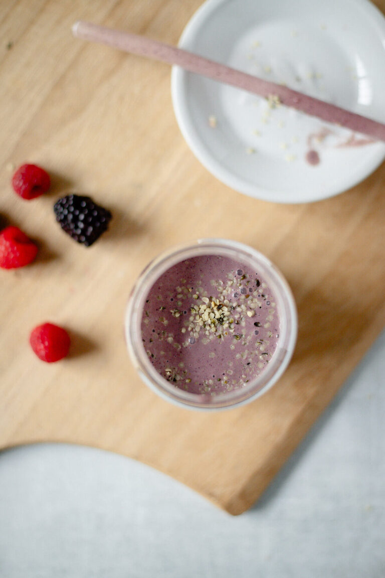 top down view of a gut friendly triple berry smoothie with hemp seeds topping