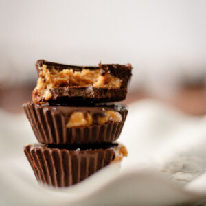 stack of homemade chocolate peanut butter cups with sea salt topping