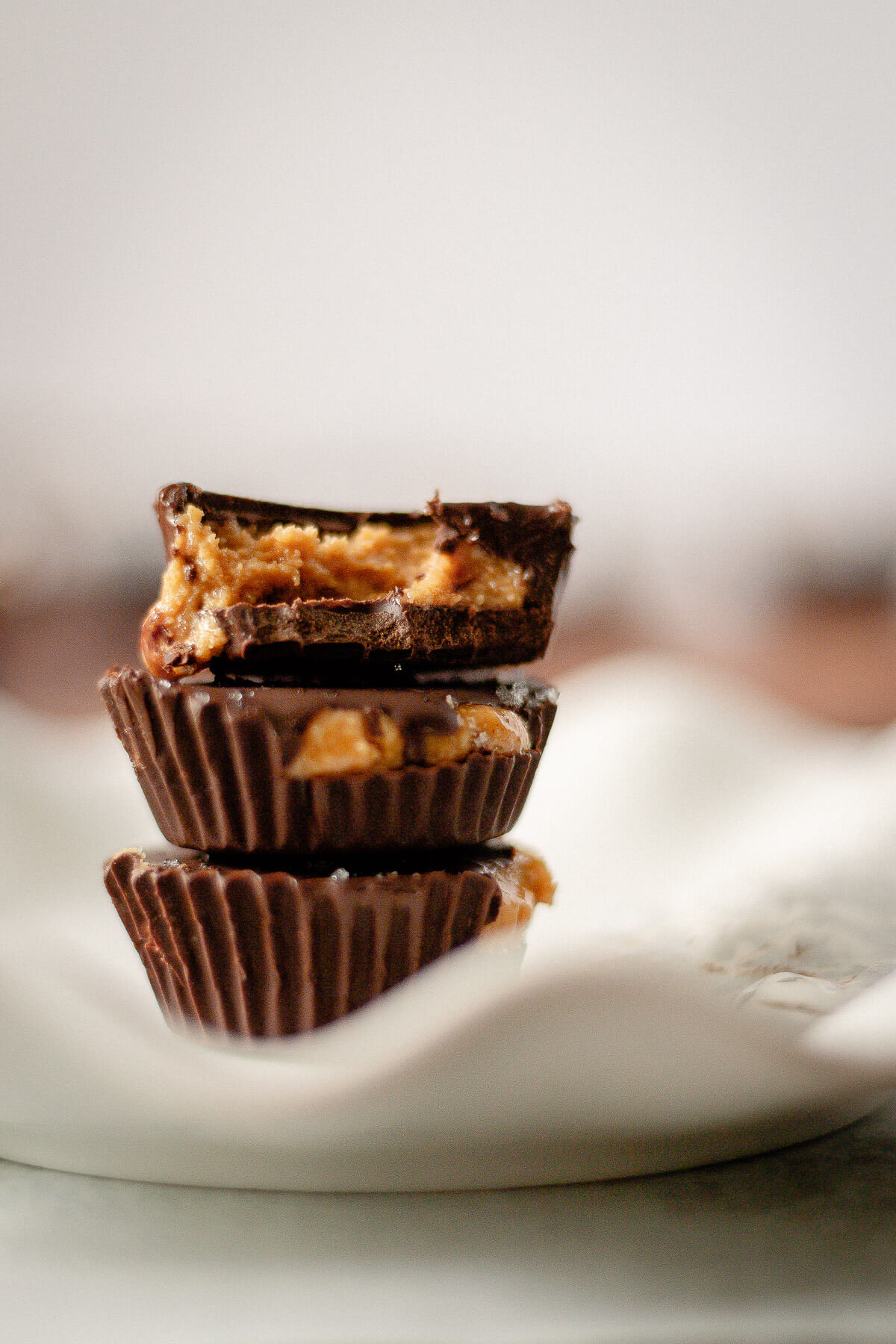 stack of homemade chocolate peanut butter cups with sea salt topping