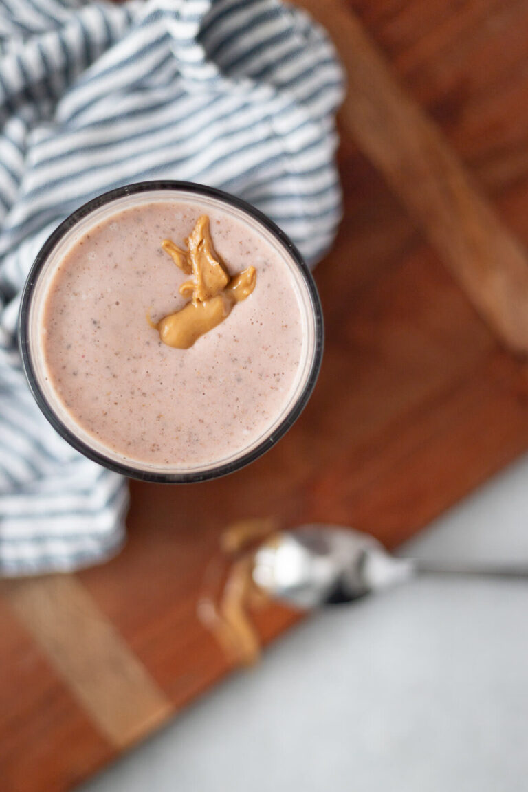 top down view of a strawberry peanut butter smoothie in a glass