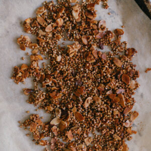 Almond Buckwheat Granola Buckwheat Groat and Almond Granola on a baking sheet with parchment paper