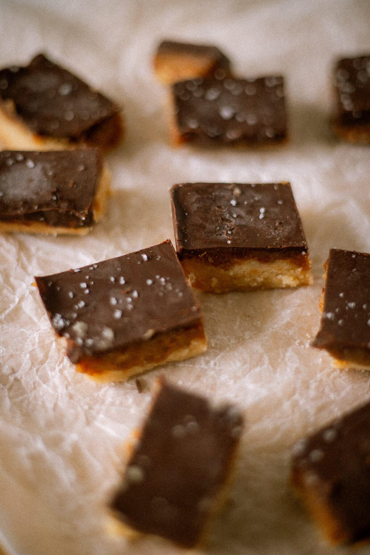 close up view of peanut butter date bars with chocolate topping and flakey sea salt