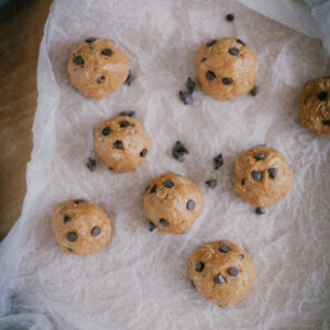 chocolate peanut butter protein balls on wax paper