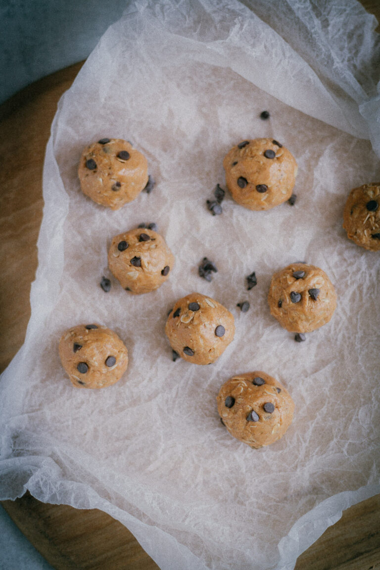 chocolate peanut butter protein balls on wax paper