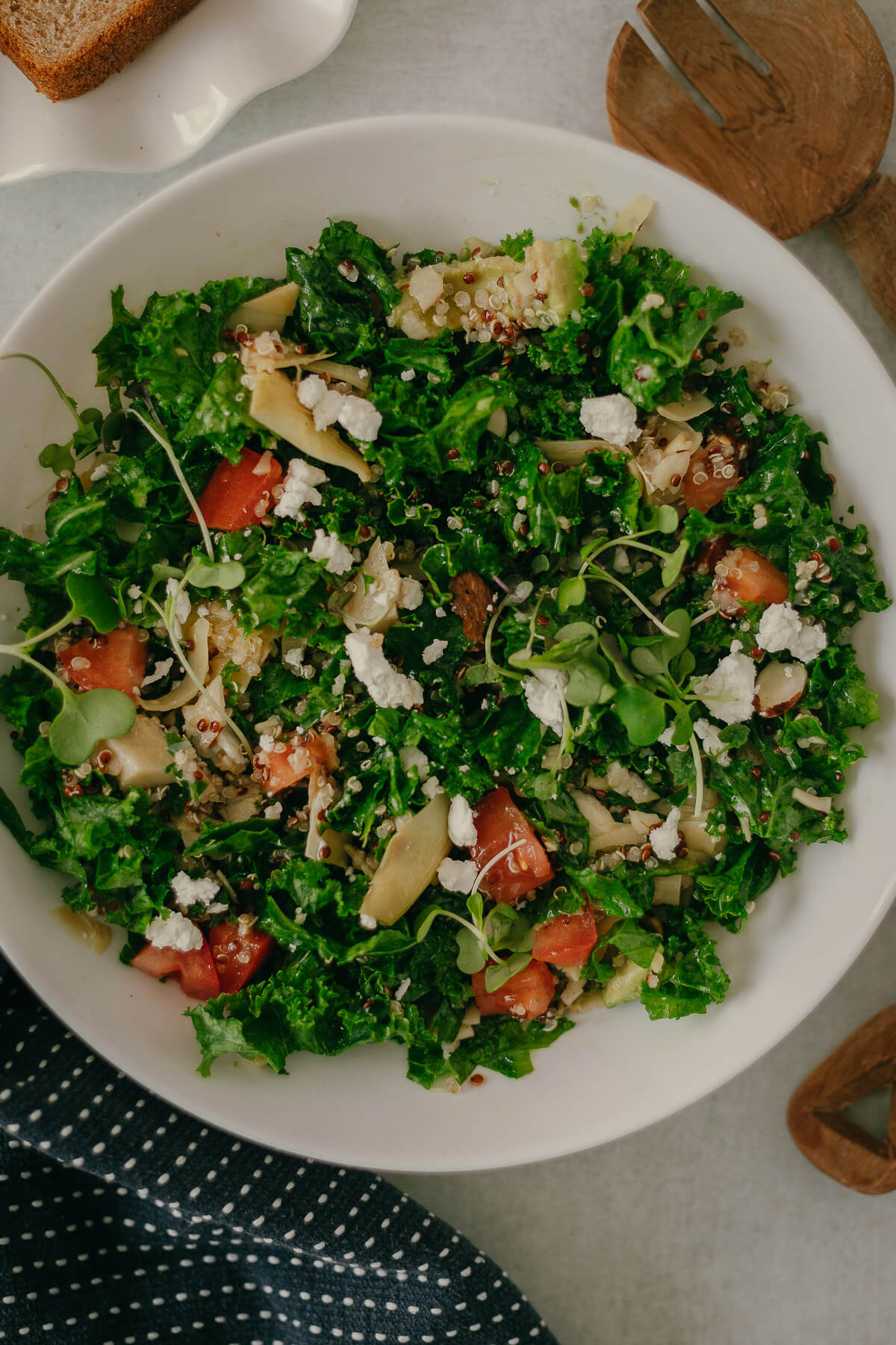 kale quinoa salad with goat cheese and artichokes in a lemon dressing