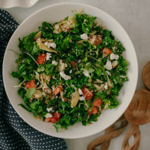 kale quinoa salad with goat cheese and artichokes in a lemon dressing