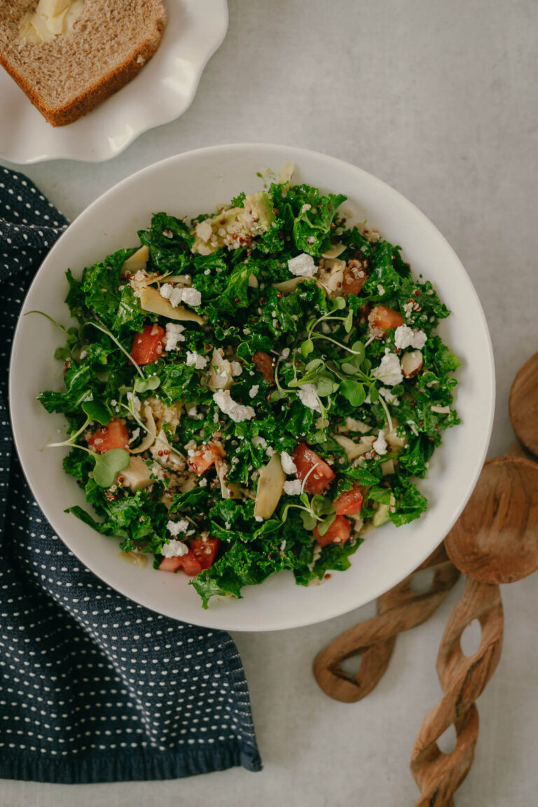kale quinoa salad with goat cheese and artichokes in a lemon dressing