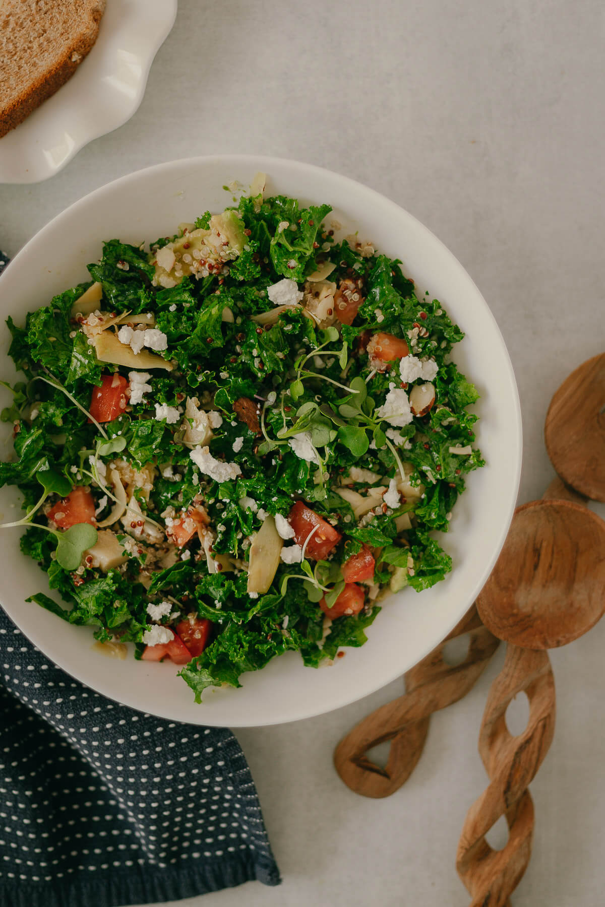 kale quinoa salad with goat cheese and artichokes in a lemon dressing