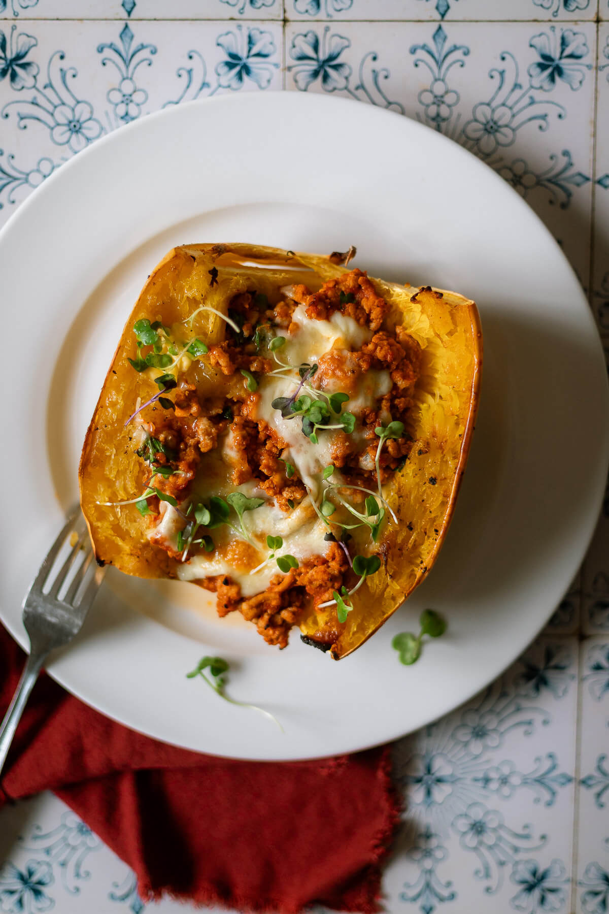 Roasted Spaghetti Squash half with turkey meat sauce and mozzarella cheese for a delicious turkey spaghetti squash bake.