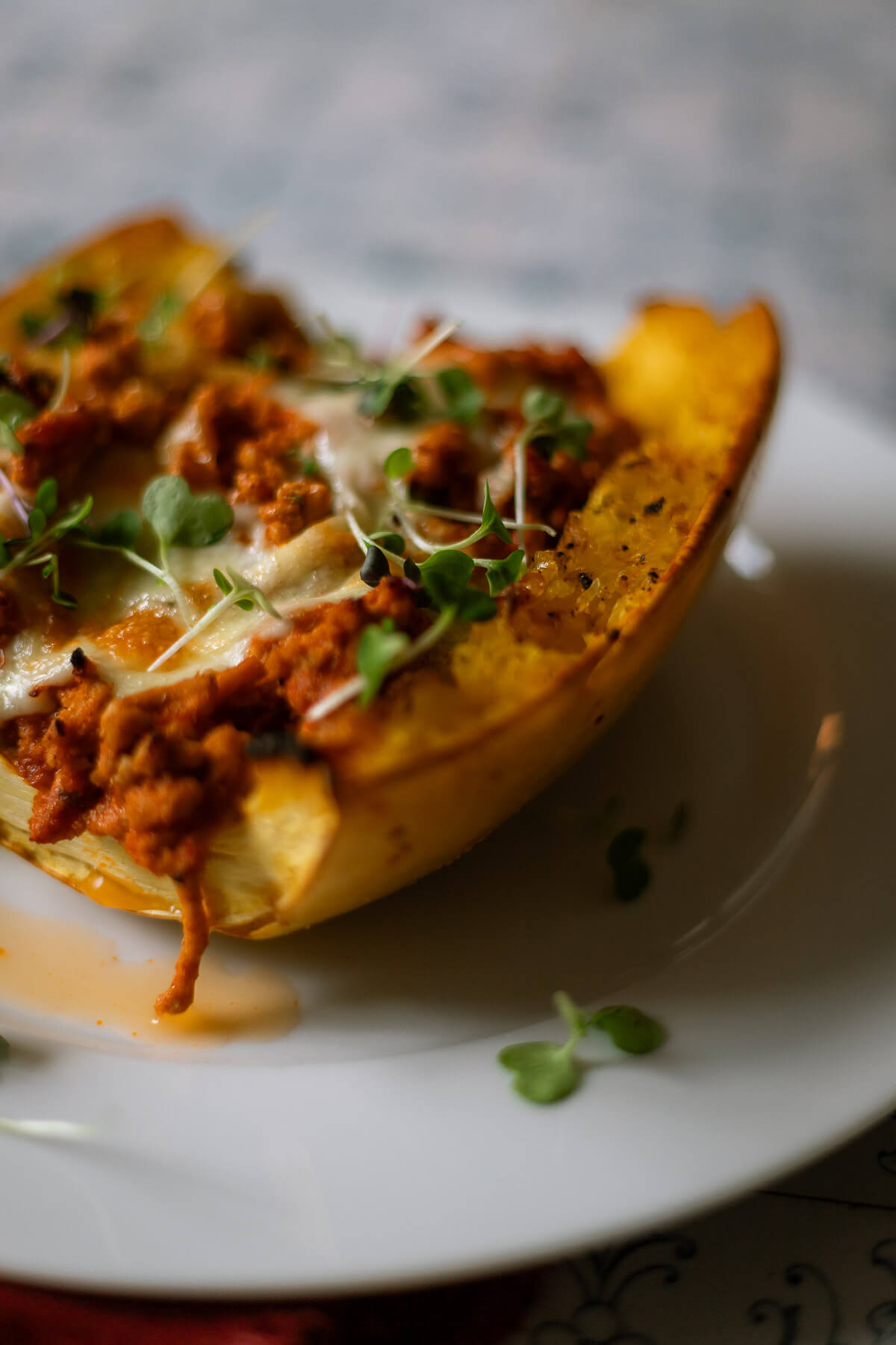 Roasted Spaghetti Squash half with turkey meat sauce and mozzarella cheese for a delicious turkey spaghetti squash bake.