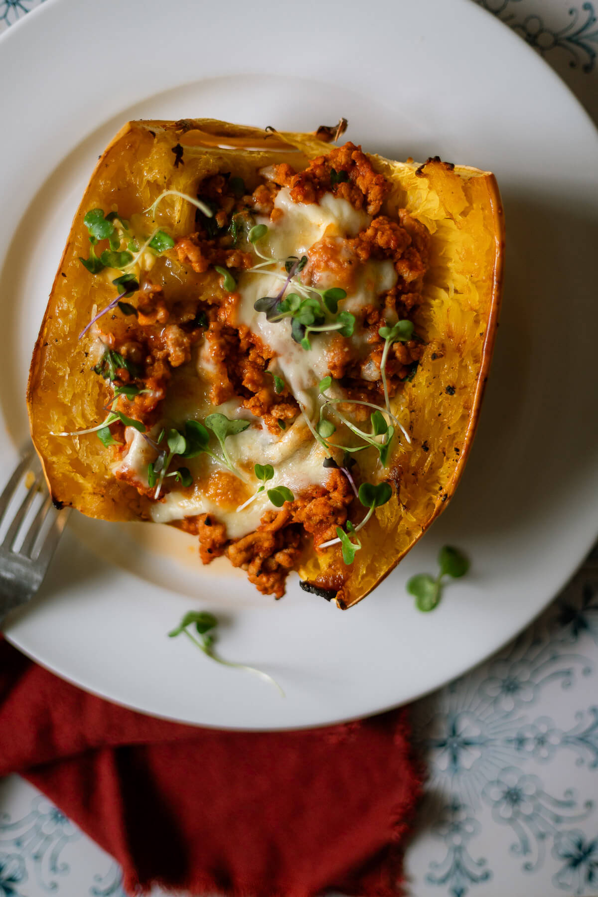 Roasted Spaghetti Squash half with turkey meat sauce and mozzarella cheese for a delicious turkey spaghetti squash bake.